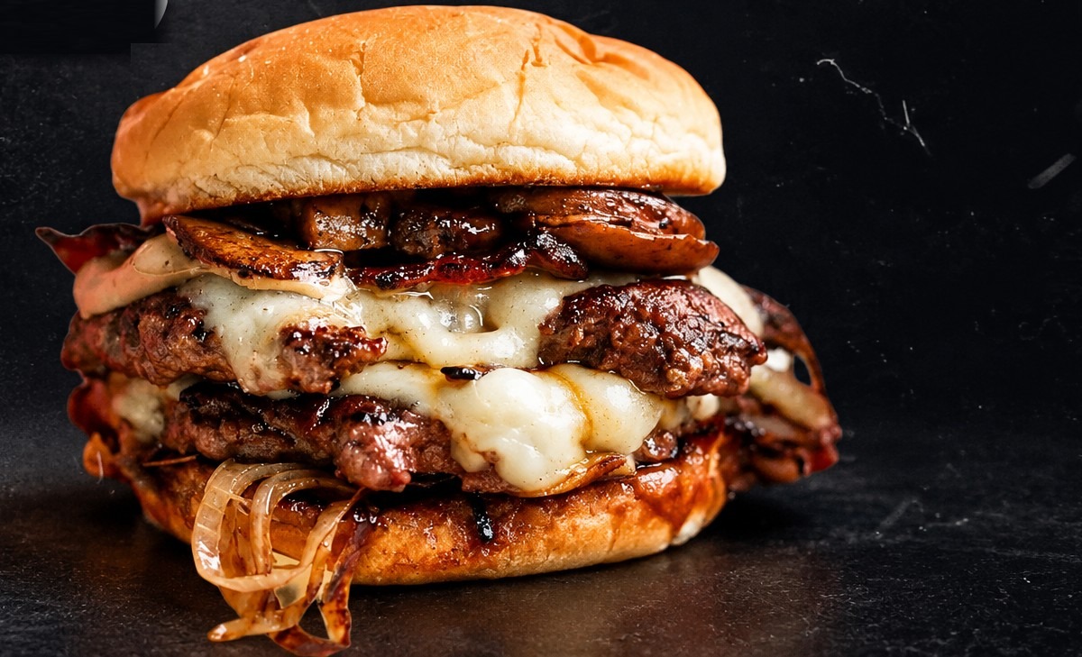 Juicy double smashed cheeseburger with bacon, onions and melted cheese